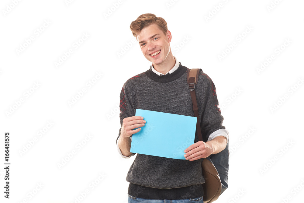 Portrait of teenage student holding blank paper against white background Portrait of teenage student holding blank paper against white background