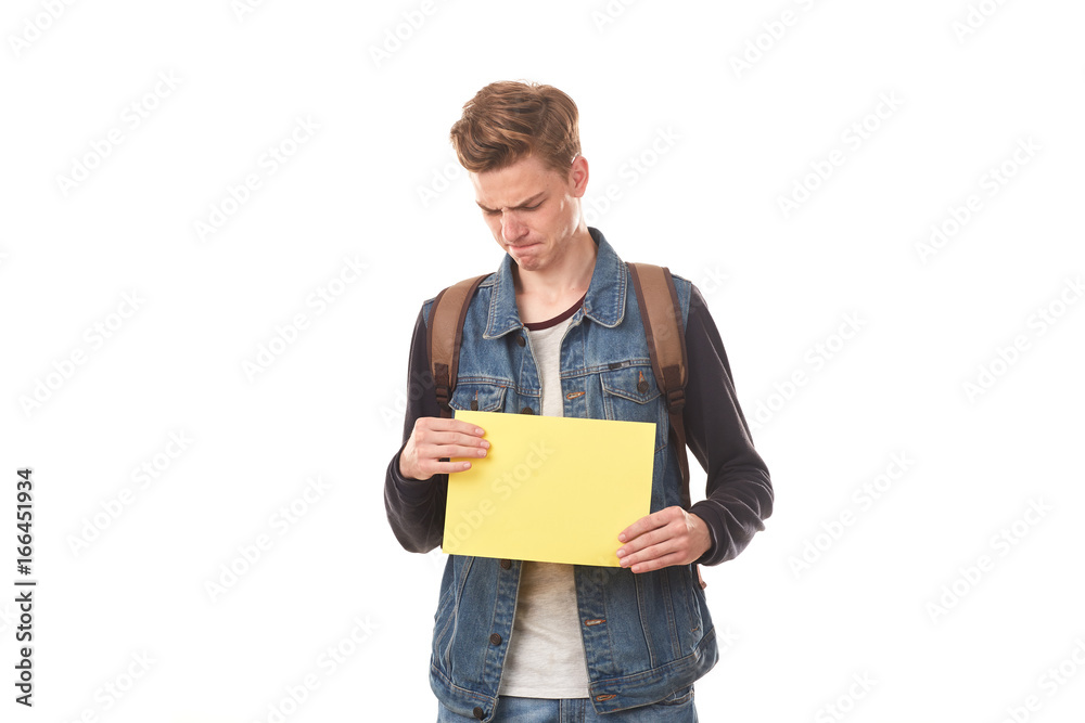 Portrait of schoolboy posing with blank paper against white background Portrait of schoolboy posing with blank paper against white background