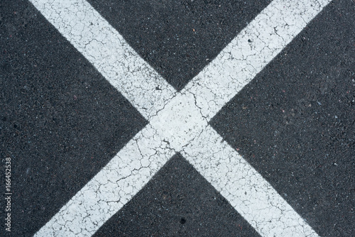 top view of white parking lines on grey roadway background