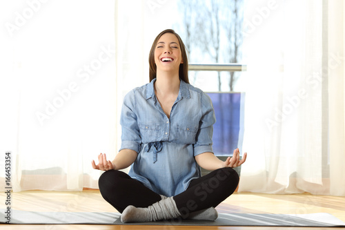 Free Download Pregnant woman practicing yoga exercises at home - GFXLoad
