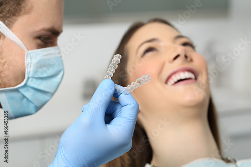 Dentist showing an implant to a patient
