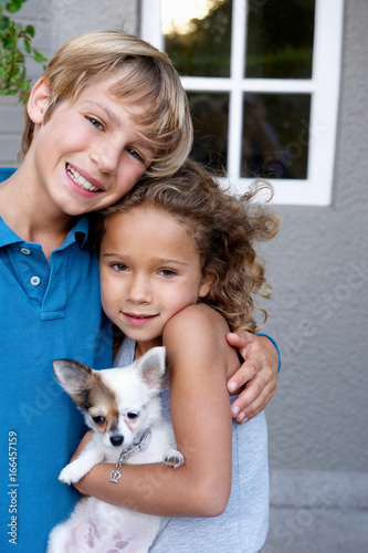 Brother and sister with their dog photo