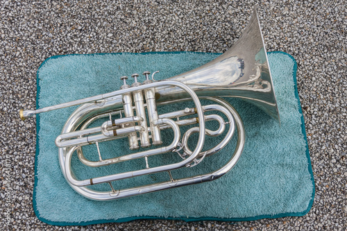 mellophone taking a break on a towel at band camp photo