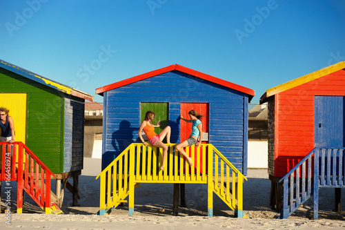 Girls hanging out at beach hut © Image Source RF