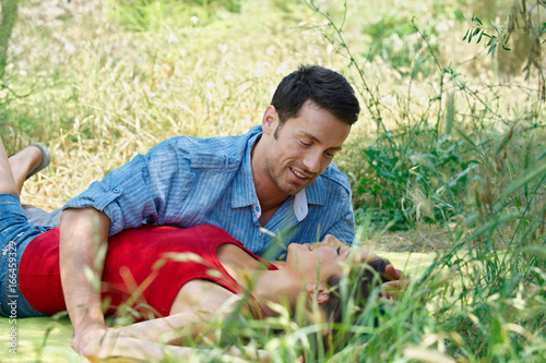 Romantic couple lying in long grass