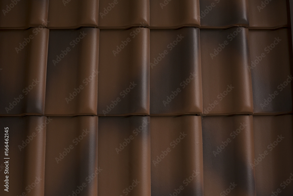 Dark brown tiles of shingles on the roof Dark brown tiles of shingles on the roof