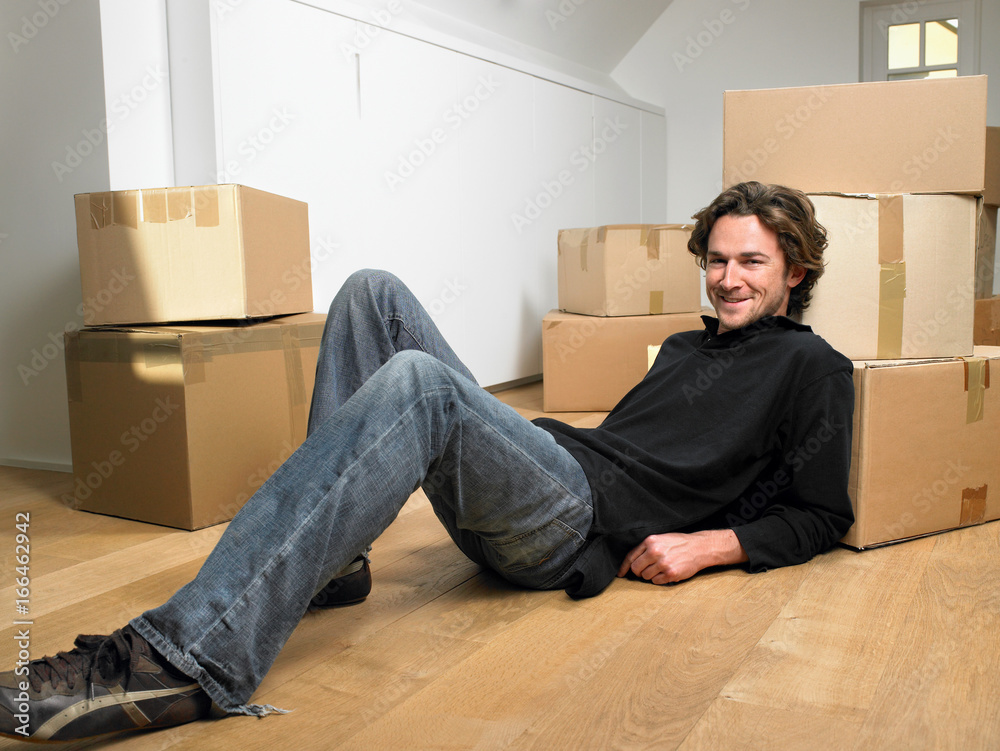 Man lying on floor smiling Man lying on floor smiling