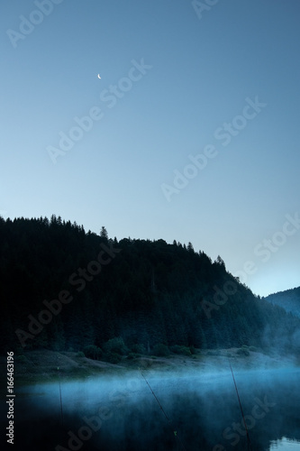 Fog on mountain lake early in the morning © IoaBal
