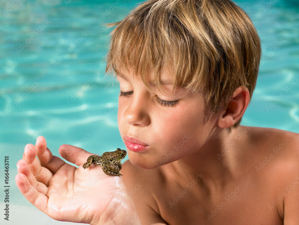 Boy holding a frog in his hand