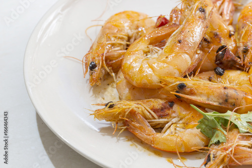 Seafood prawns closeup on a white dish.