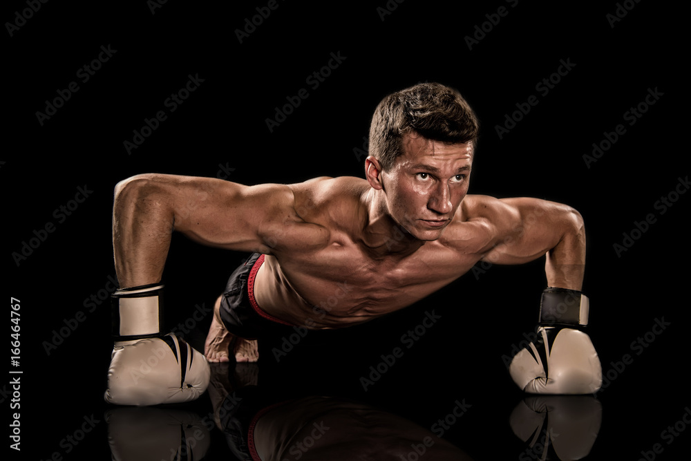 Athletic bodybuilder pose in pants.