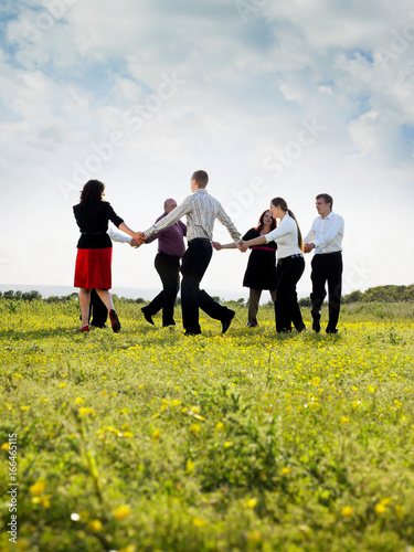 Group of businesspeople in a field.