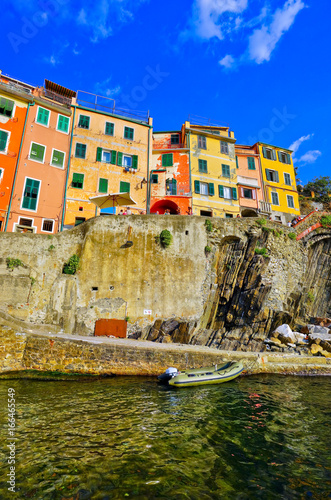 View of the colorful houses along the coastline of Cinque Terre area in Riomaggiore, Italy. photo