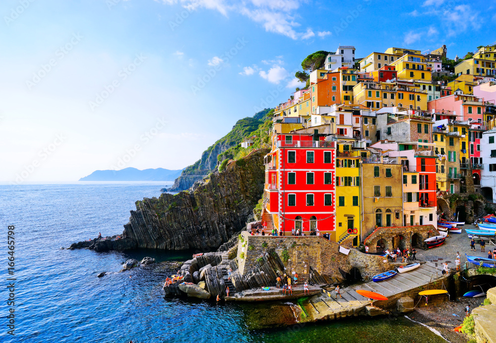 View of the colorful houses along the coastline of Cinque Terre area in Riomaggiore, Italy.