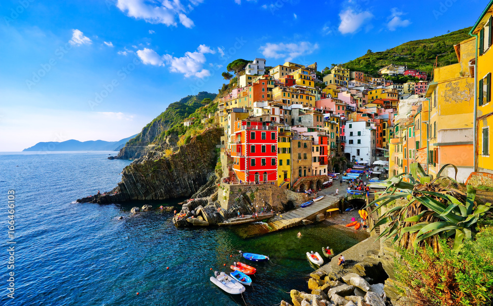 View of the colorful houses along the coastline of Cinque Terre area in Riomaggiore, Italy.
