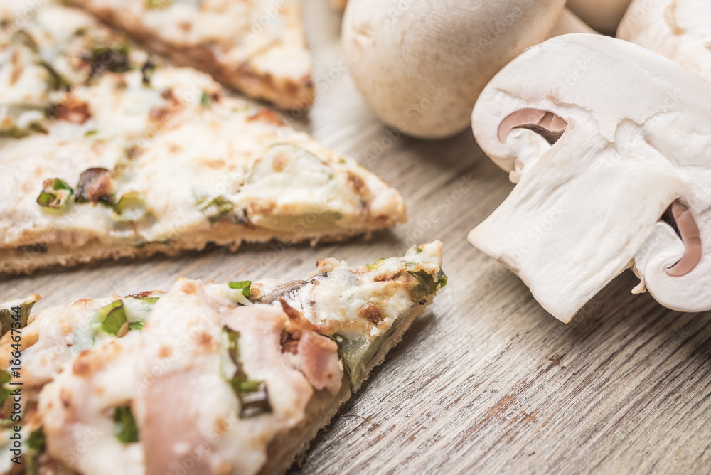 Pieces of pizza with ham and mushrooms champignons closeup Pieces of pizza with ham and mushrooms champignons closeup