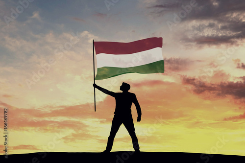 Fototapet Male silhouette figure waving Hungary flag. 3D Rendering