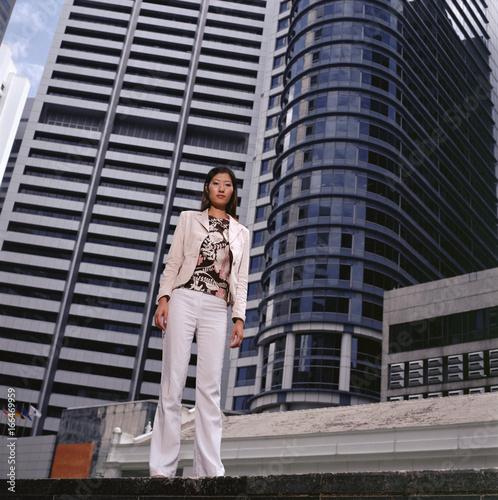 Woman standing near skyscrapers