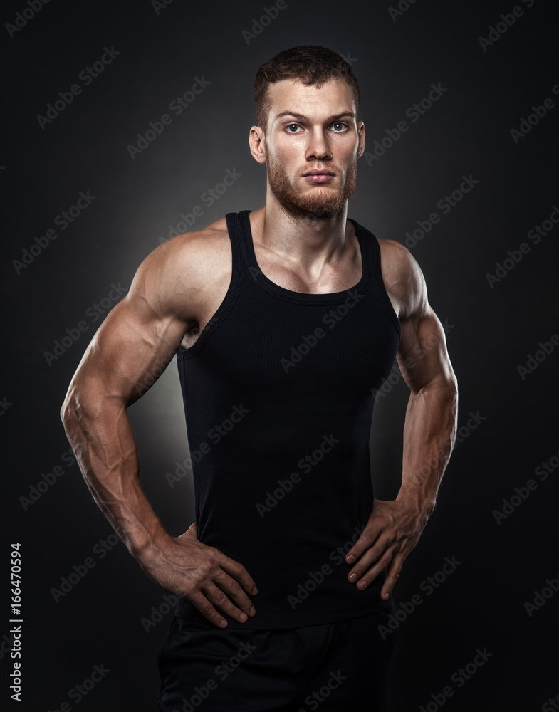 Portrait of a muscular male model against black background Portrait of a muscular male model against black background