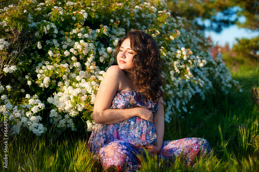 Pregnant caucasian woman takes rest outdoor Pregnant caucasian woman takes rest outdoor