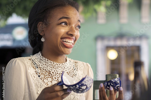 Young woman breaks a coffee cup photo