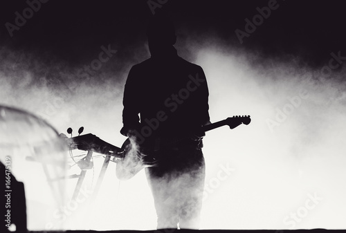 Photography Guitarist playing live in stage lights