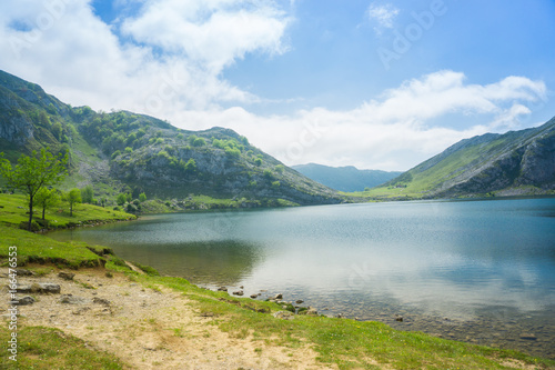 Beautiful nature of Spain: Covadonga mountain lakes in summer sunny day with blue sky and clouds