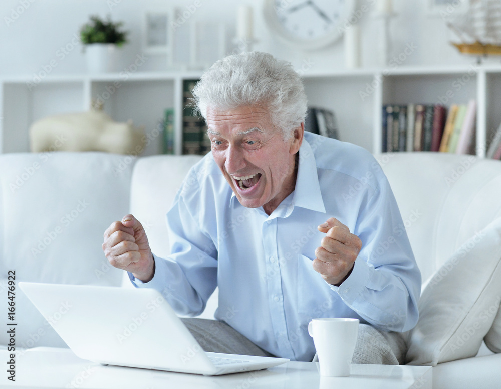 senior man using laptop senior man using laptop