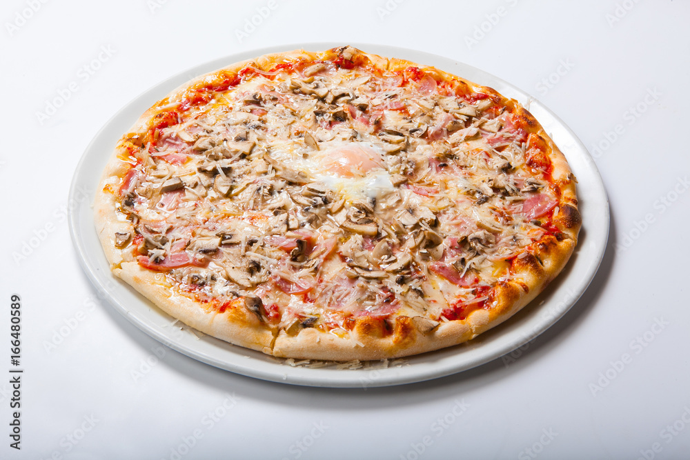 Italy pizza with egg yolk ham mushrooms on a white background Italy pizza with egg yolk ham mushrooms on a white background