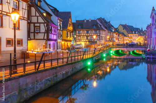 Traditional Alsatian half-timbered houses and river Lauch in Petite Venise or little Venice, old town of Colmar, decorated and illuminated at christmas time, Alsace, France