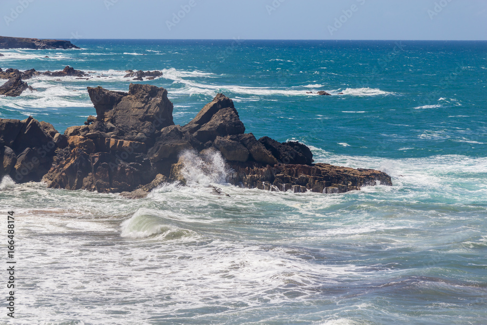 Fototapeta premium Waves craching into rocks in Vila Nova das Milfontes