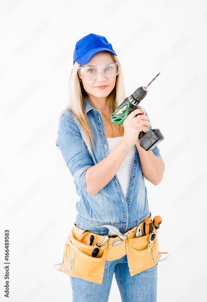 Beautiful young woman contractor with toolbelt and drill on white Beautiful young woman contractor with toolbelt and drill on white