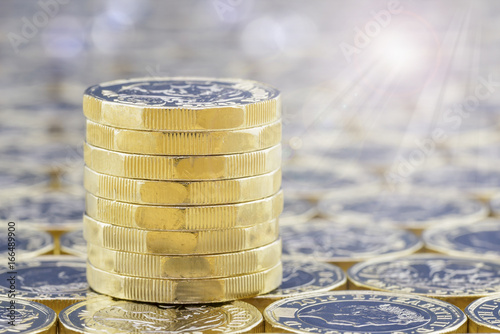 Stack of golden coins with bright sunlight light effects. photo