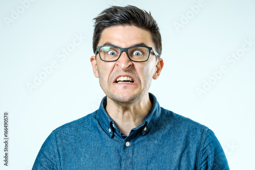 Portrait of young angry screaming man