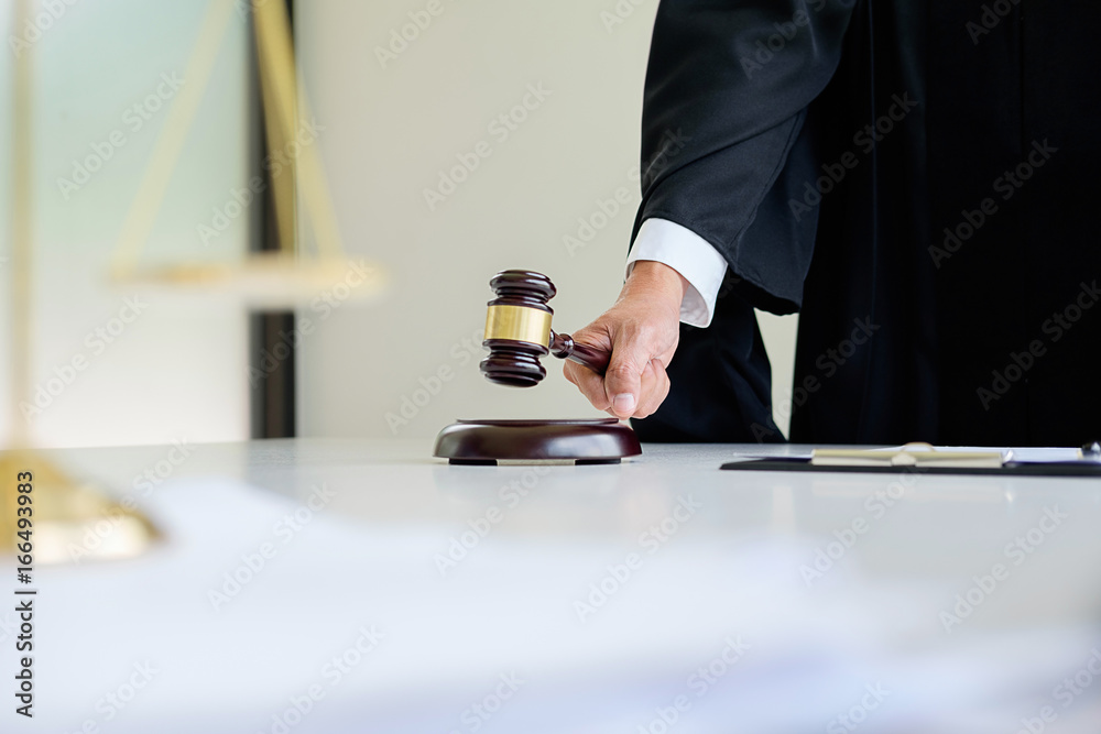Judge gavel with Justice lawyers having team meeting at law firm in background. Concepts of law. Judge gavel with Justice lawyers having team meeting at law firm in background. Concepts of law.