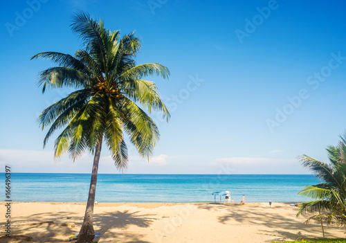 Beach with white sand and blue sea and sky in summer season © jimbophotoart