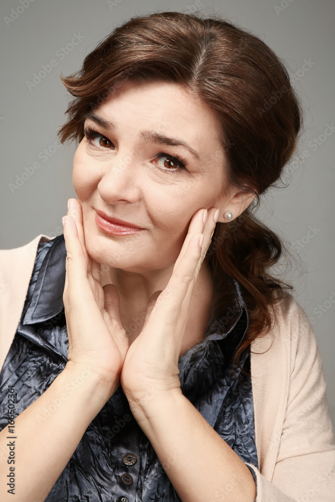 Beautiful elderly woman posing on light background Beautiful elderly woman posing on light background