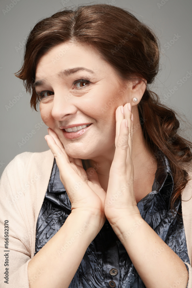 Beautiful elderly woman posing on light background Beautiful elderly woman posing on light background