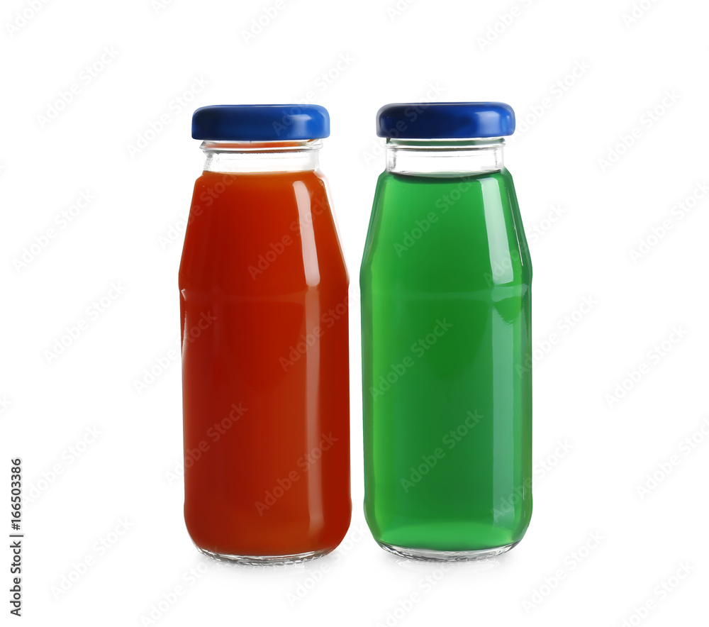 Different juices in bottles on white background