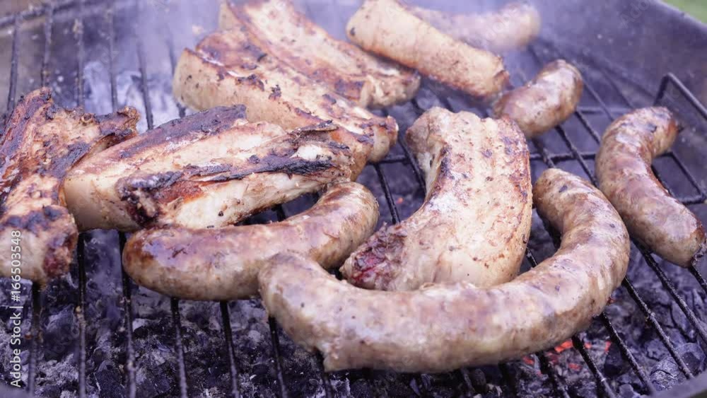 Chef is flipping meat on grill. Barbecue meat preparing on grill, close up. Mutton or pork grilling. Chef is flipping meat on grill. Barbecue meat preparing on grill, close up. Mutton or pork grilling.