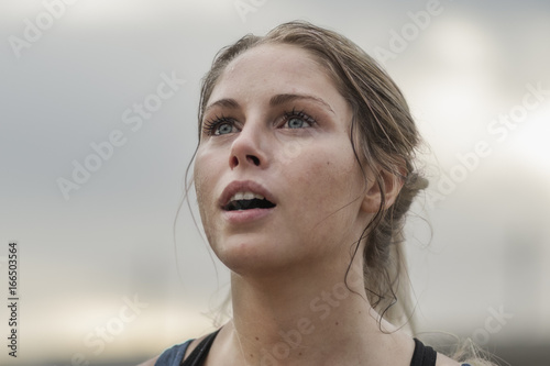 a woman looking up catching her breath after running