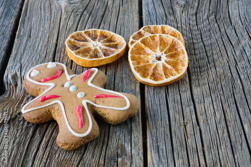 Dried oranges and cakes on wooden background. Christmas concept. .Gingerbread man