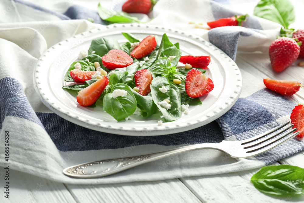 Tasty salad with spinach and strawberry on plate Tasty salad with spinach and strawberry on plate