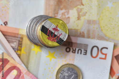 euro coin with national flag of brunei on the euro money banknotes background.