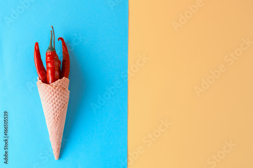 Unusual ice cream. Red hot chili peppers in a wafer cone photo