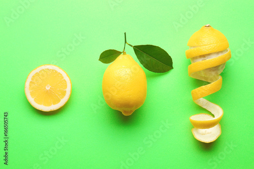 Delicious fresh lemons on color background