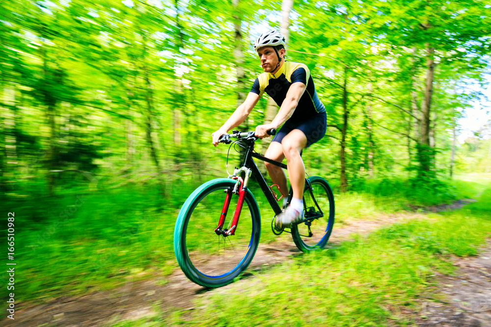 Fototapeta premium Young Man Riding His Mountain Bike