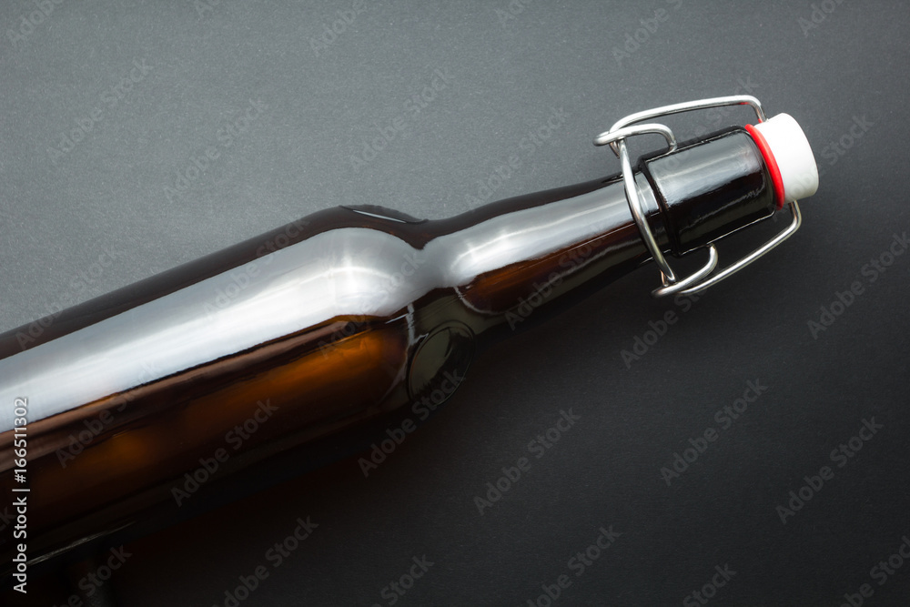 Old brown bottle of beer isolated on black background. Old brown bottle of beer isolated on black background.