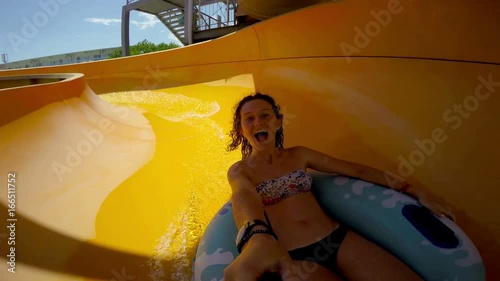 Girl goes down the waterslide tube at aqua 