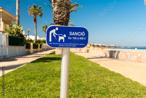 A sign announcing the ban on dogs on the beach in L'Hospitalet de l'Infant, Tarragona, Catalunya, Spain. Copy space.